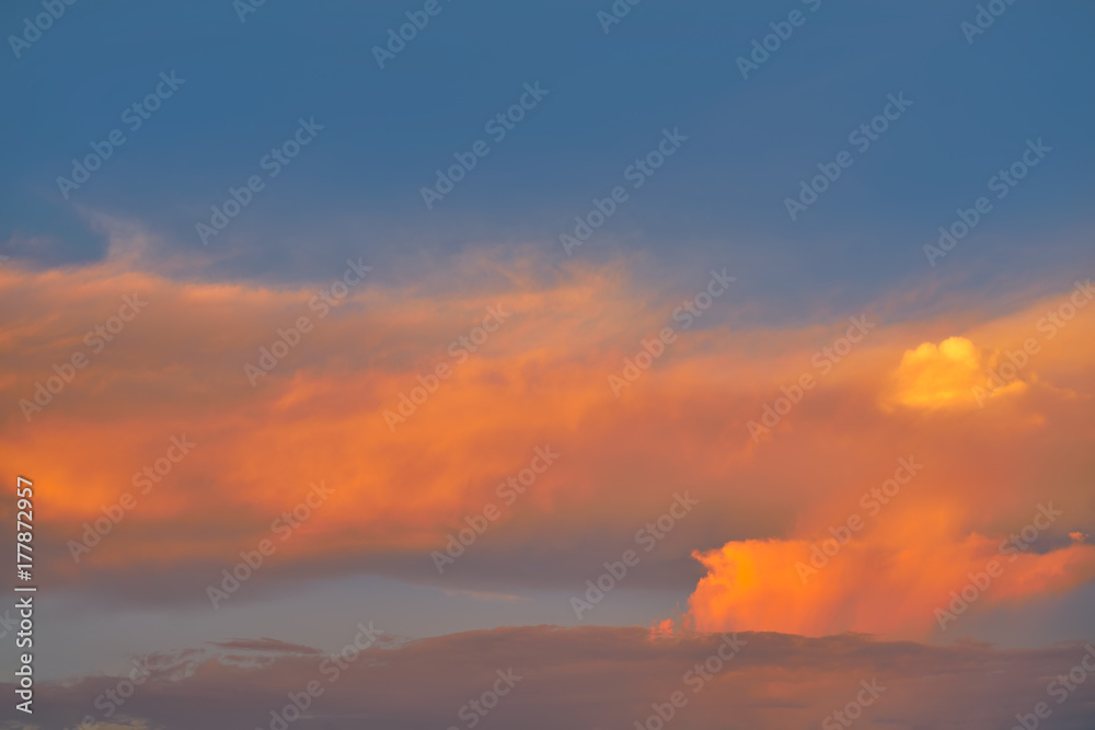 Sunset sky orange clouds on blue