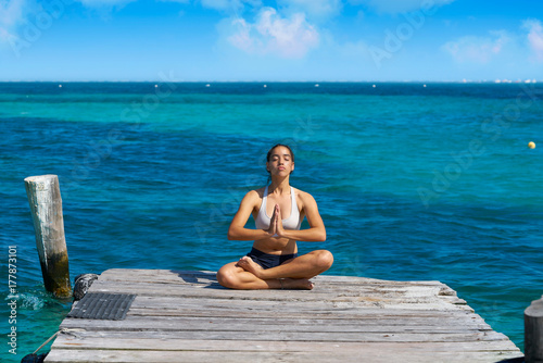 Latin woman yoga relaxing in Caribbean