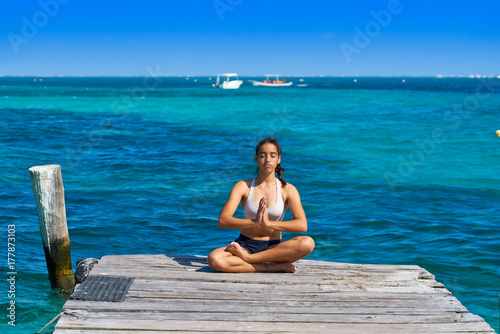 Latin woman yoga relaxing in Caribbean © lunamarina