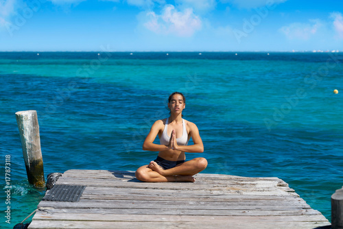 Latin woman yoga relaxing in Caribbean