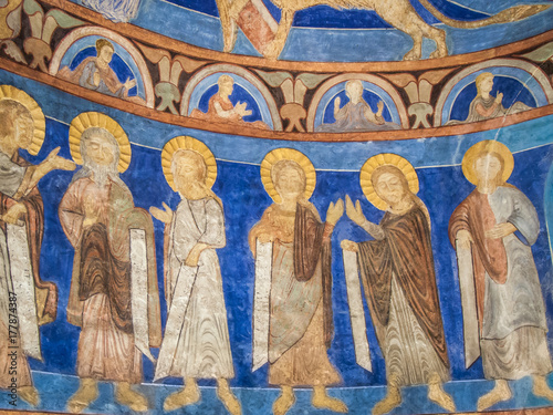 Six apostles with golden halos in stucco and text-bands in their hands, a romanesque wall-painting from the 1200s in a Swedish church