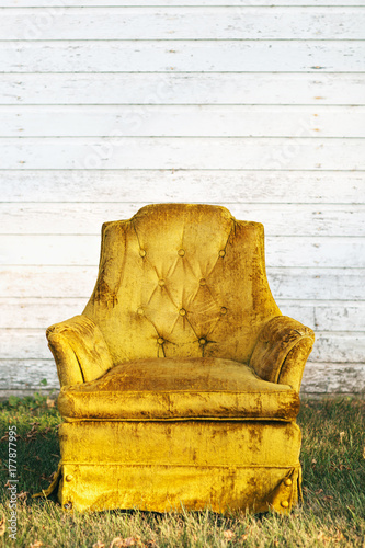 vintage velvet chair in front of an old house
