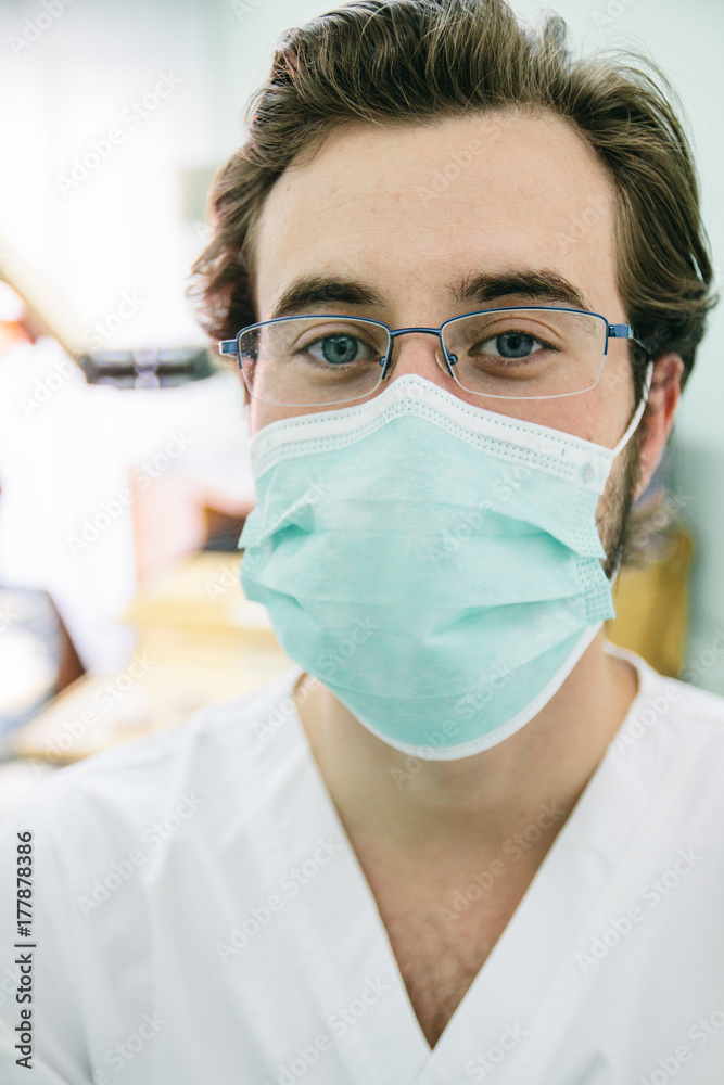Portrait of a dentist with a surgical mask in a dental clinic Portrait of a dentist with a surgical mask in a dental clinic