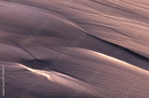 Sand patterns on the Pacific Coast at sunset created by ocean tides
