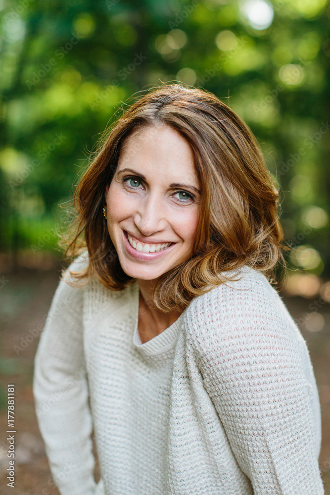 Portrait of a beautiful woman standing outside in a sweater Portrait of a beautiful woman standing outside in a sweater