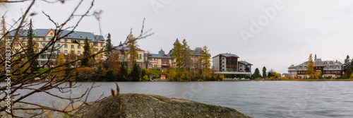 Strbske Pleso. Luxury Hotel at Strbske Pleso Lake. Autumn colours, rainy day. Panorama 3:1