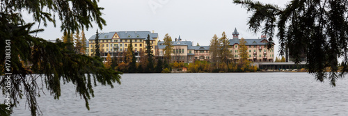 Strbske Pleso. Luxury Hotel at Strbske Pleso Lake. Autumn colours, rainy day. Panorama 3:1