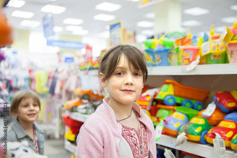 girl in   toy store choosing   toys