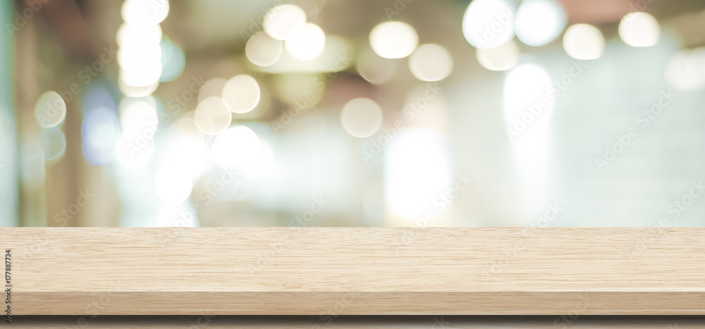 Empty wooden table over blur store background, product and food display montage background Empty wooden table over blur store background, product and food display montage background