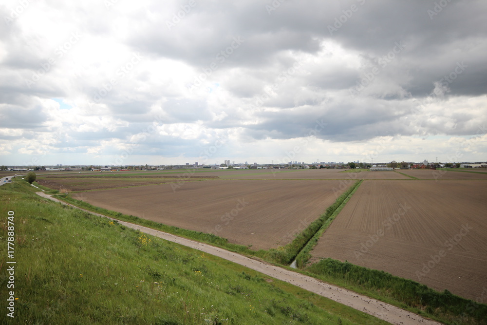 wide overview of the Zuidplaspolder, the lowest area of Netherlands with village Zevenhuizen en Skyline Rotterdam in the background