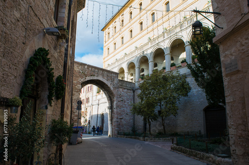Archway between elegant architecture in the streets of Assisi, Umbria, Italy