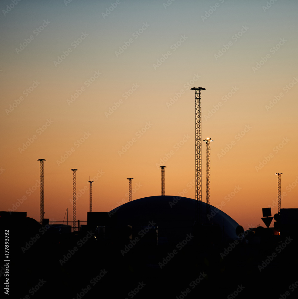 Light posts and a dome silhouette on sunset