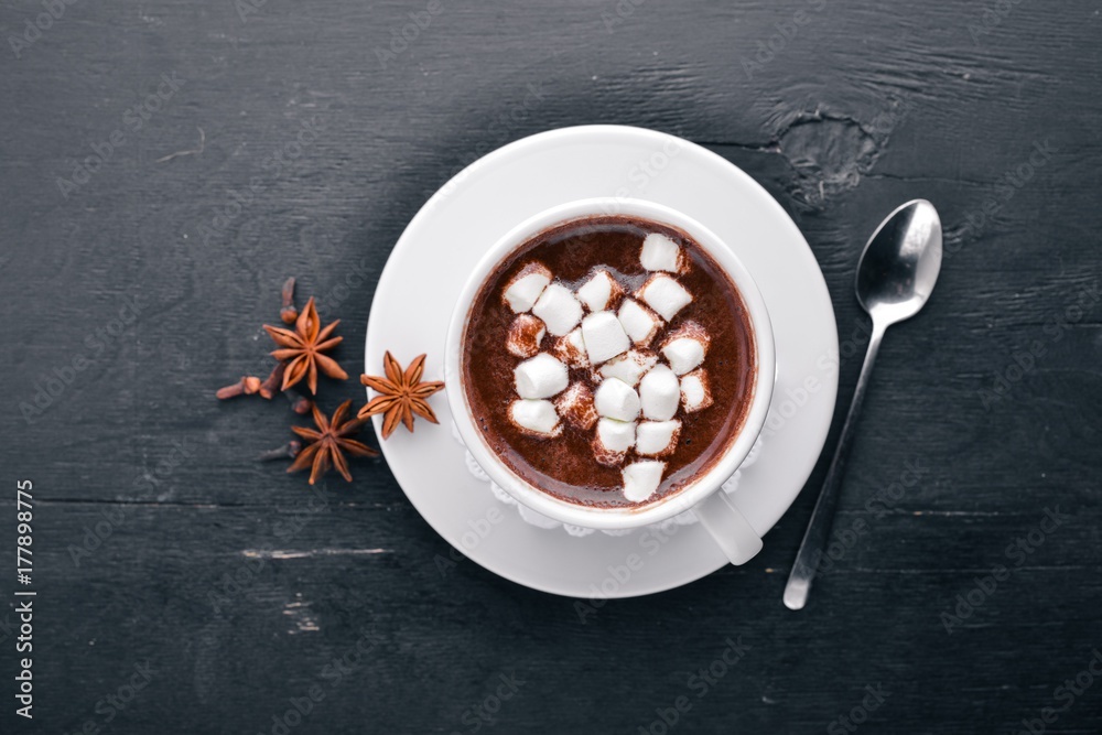 Cappuccino with marshmallow. On a wooden background. Top view. Free space for your text.