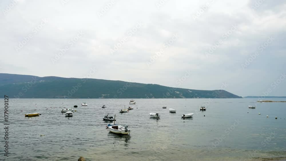 Herceg-Novi, Montenegro - September 26: small white motor boats in the Bay in Montenegro in autumn in the European day of languages on September 26, 2017 Herceg-Novi, Montenegro - September 26: small white motor boats in the Bay in Montenegro in autumn in the European day of languages on September 26, 2017