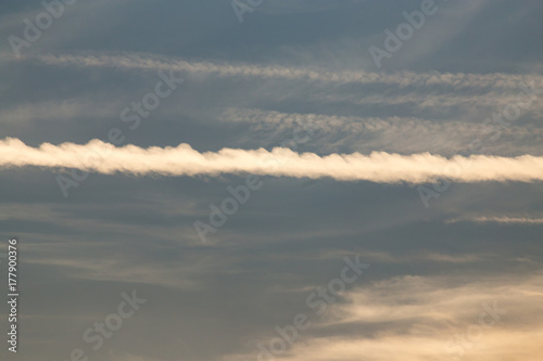 trail from the plane in the sky at sunset © schankz