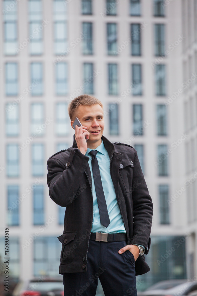 guy in business style clothes on tall building background talking on phone guy in business style clothes on tall building background talking on phone