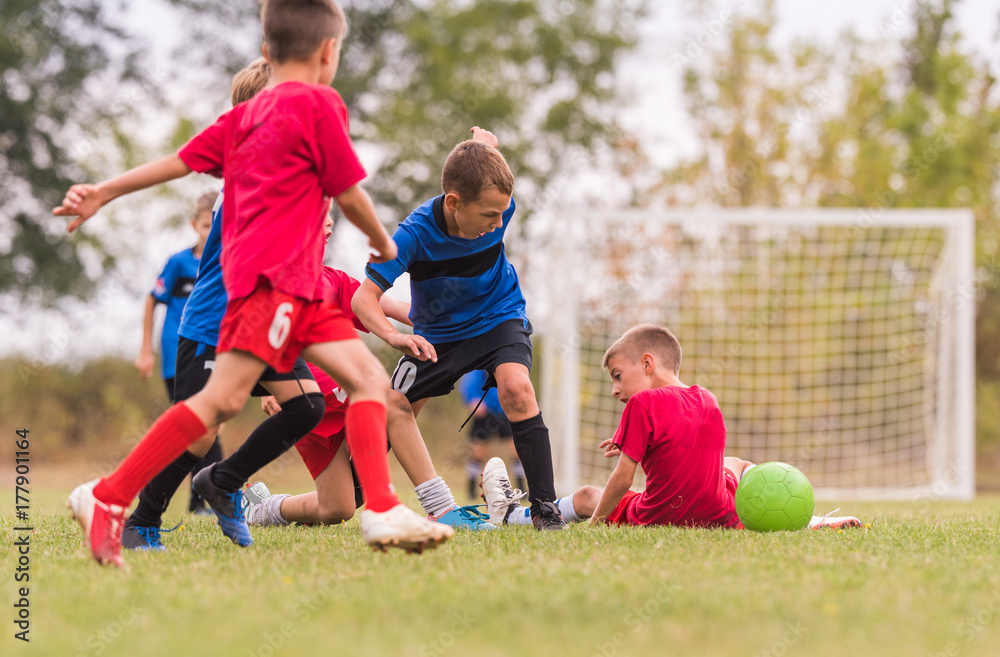 Kids soccer football - children players match on soccer field Kids soccer football - children players match on soccer field