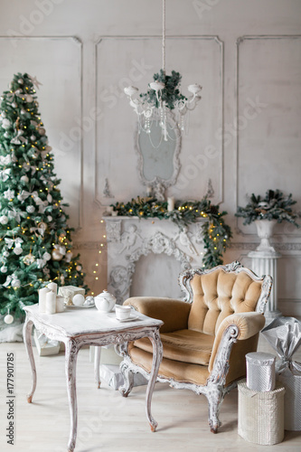 Christmas room with decorated wooden chair and table © malkovkosta