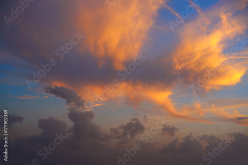 Sunset sky with orange golden clouds