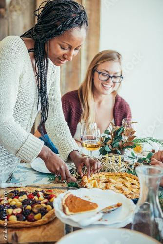 Friends enjoying thanksgiving dinner party photo