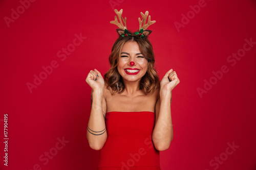 Portrait of an excited smiling girl wearing christmas deer costume