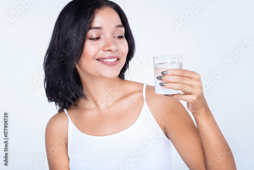 Cheerful woman holding a glass of water