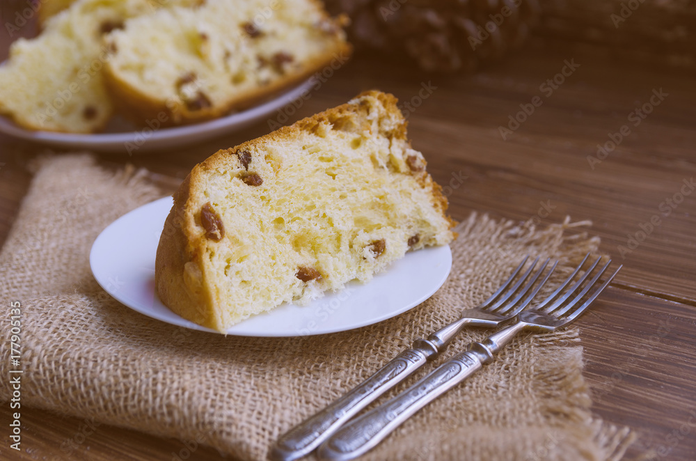 Panettone, Traditional Italian Christmas cake on rustic background with vintage forks. Copy space.
