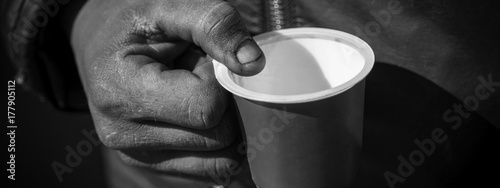 Obraz na plátně Dirty Beggar Hand Holding Plastic Cup