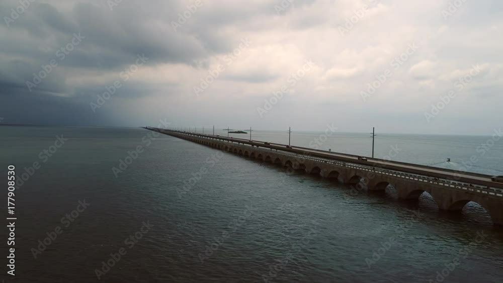 Florida Keys bridge under dramatic, overcast sky, aerial footage. Florida Keys bridge under dramatic, overcast sky, aerial footage.
