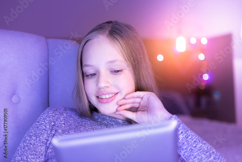 Alive smiling girl using her tablet photo