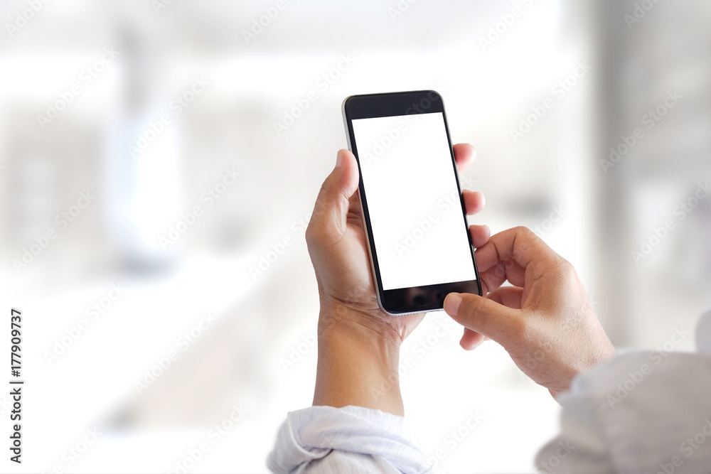 Mockup smartphone blank screen in man hands in blurred office interia background. Mockup smartphone blank screen in man hands in blurred office interia background.