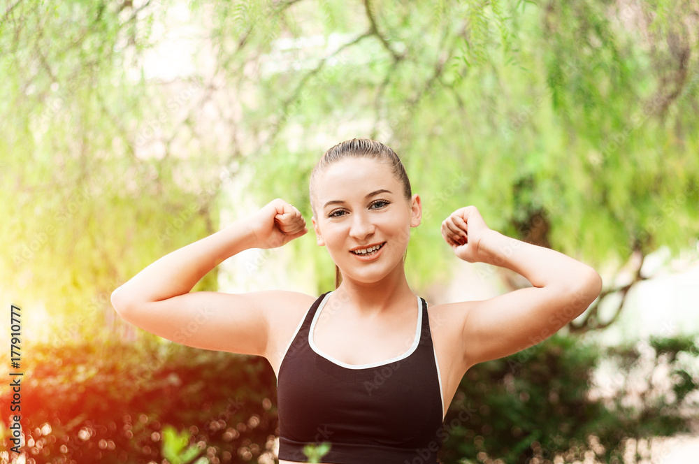 Winning, success concept. Beautiful, fitness sport girl rejoices in victory, raises her hands up. Girl rejoices victory with fists, victory sign . Positive emotions and feelings. Winning, success concept. Beautiful, fitness sport girl rejoices in victory, raises her hands up. Girl rejoices victory with fists, victory sign . Positive emotions and feelings.