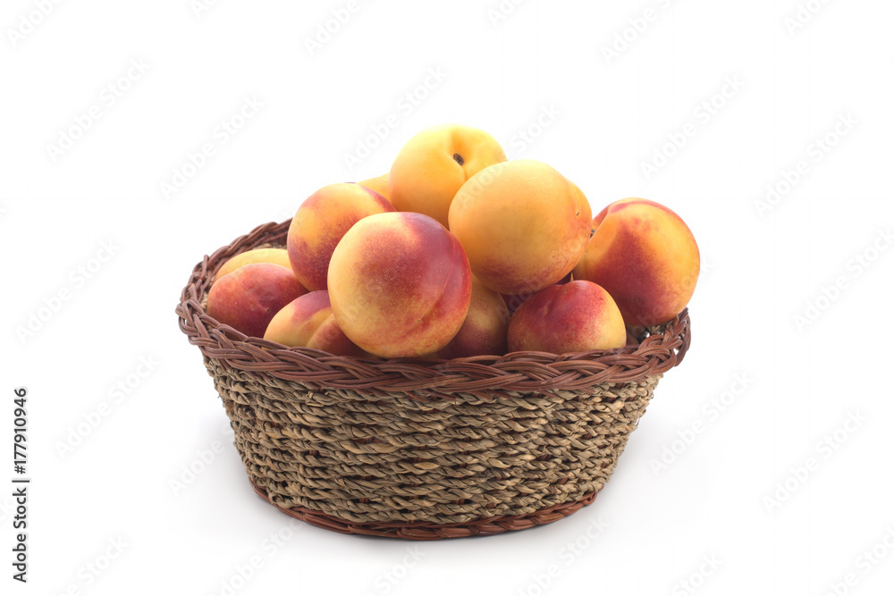 Nectarines in a basket on a white background Nectarines in a basket on a white background
