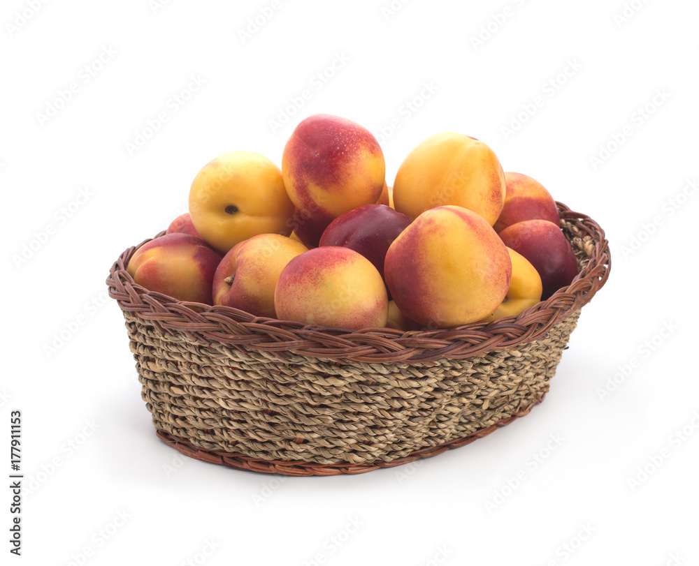 Ripe nectarines small, lying in a wicker basket Ripe nectarines small, lying in a wicker basket