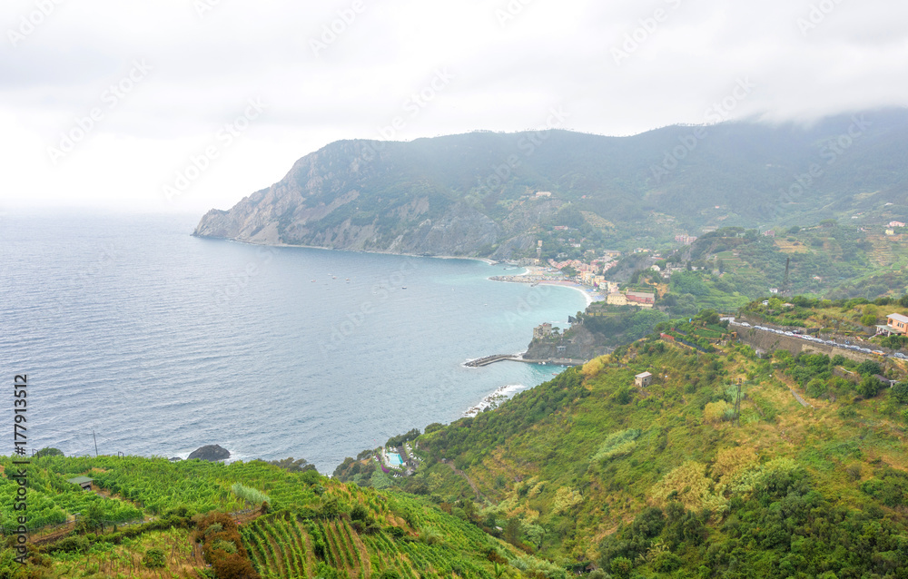 Beautiful fog view from mountains to sea,trees and beachline. Monterosso al Mare, Cinque Terre, Italy