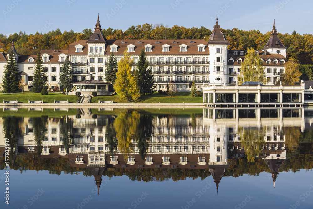 Facade of the tourist complex against the background of the lake and autumn park