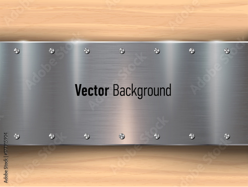 Metal plates on wooden background.