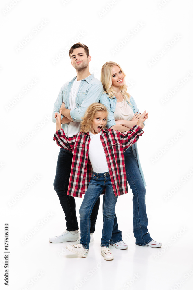 Full length portrait of a young beautiful family standing together