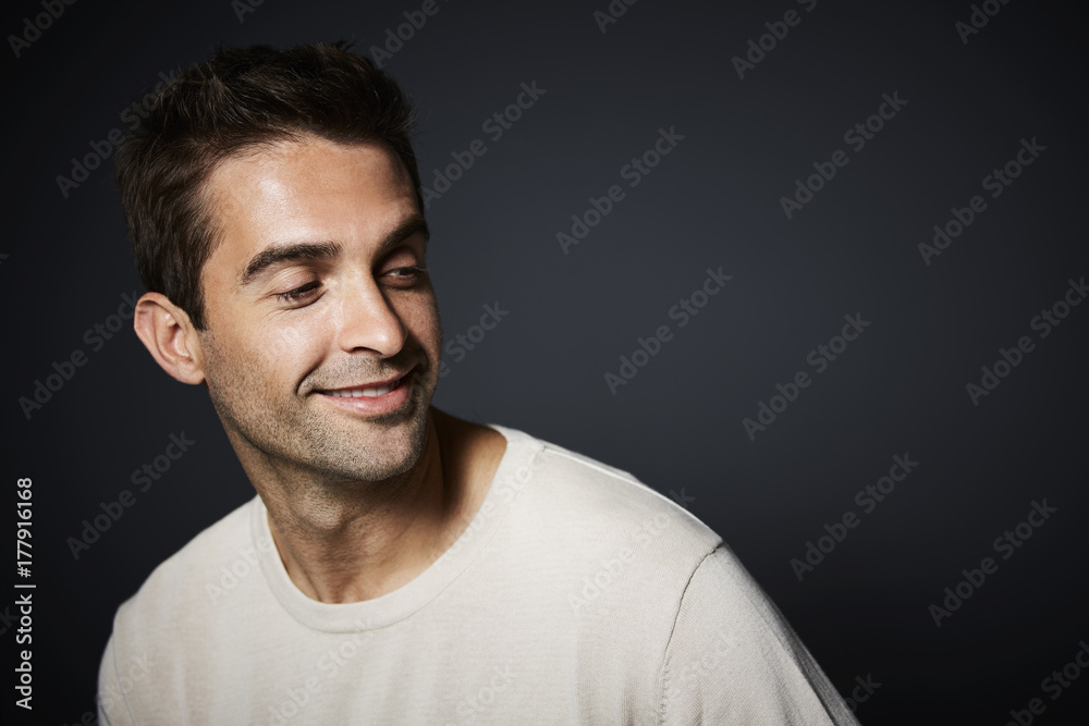 Smiling dude in studio smiling and looking away Smiling dude in studio smiling and looking away