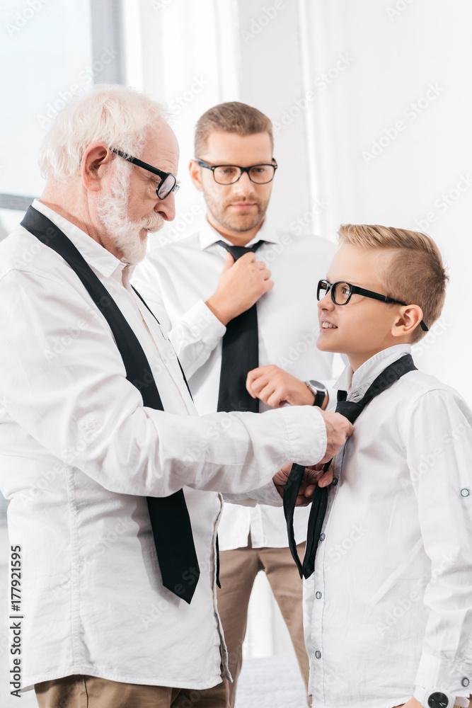 grandfather helping grandson with necktie grandfather helping grandson with necktie