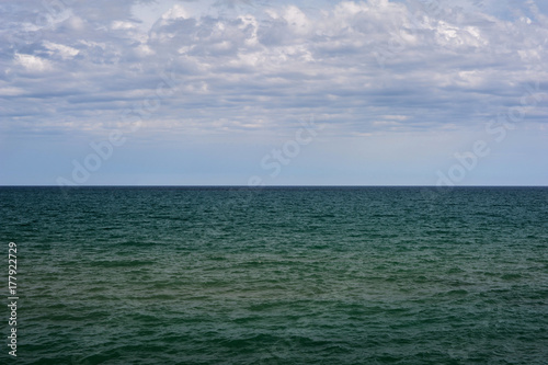Horizon of mediterranean sea with clouds in the sky