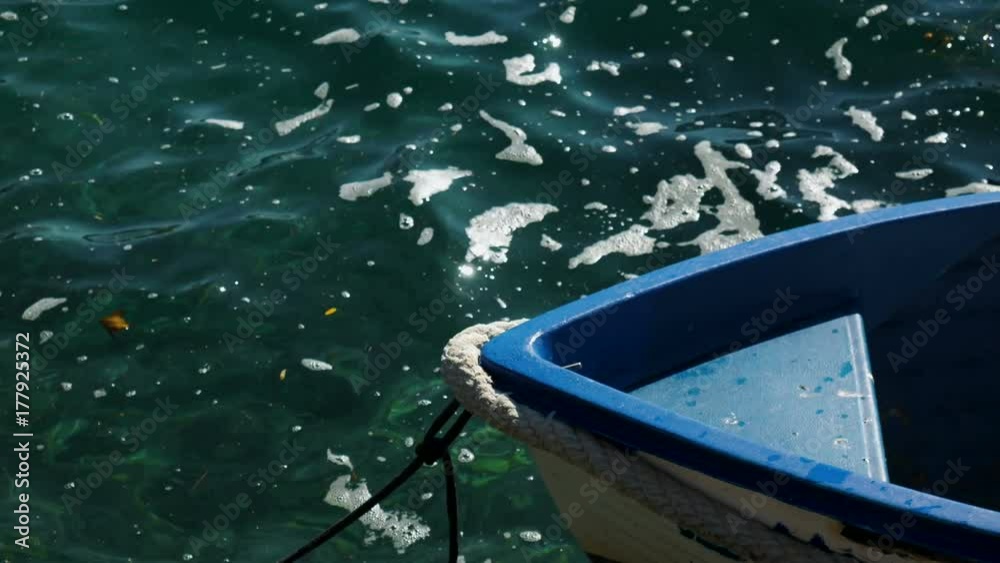 approached a white wooden boat with orange buoy in the water in the Bay of Montenegro approached a white wooden boat with orange buoy in the water in the Bay of Montenegro