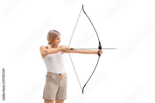 Young woman aiminig with a bow and arrow