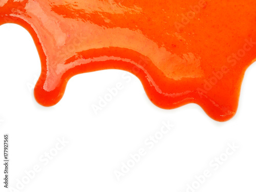 Chili sauce dripping on white background