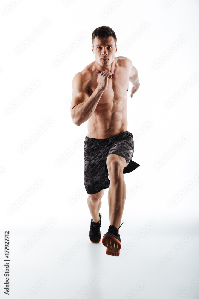 Full length portrait of young attractive runner in motion Full length portrait of young attractive runner in motion