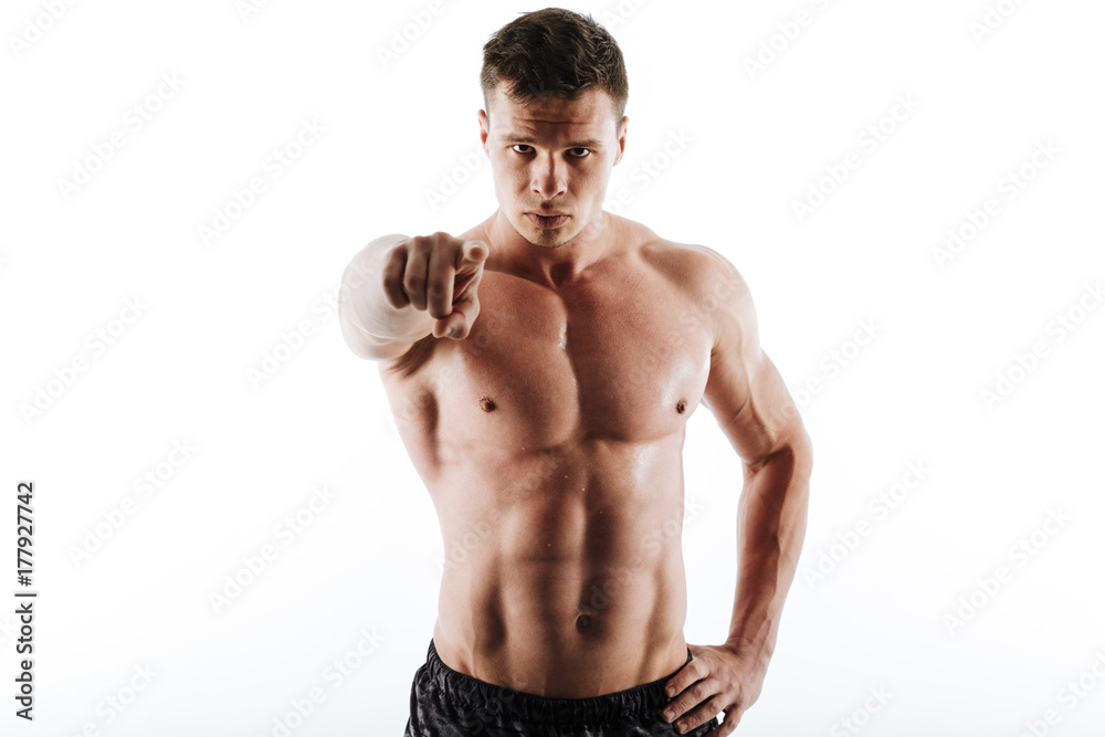 Close-up portrait of young caucasian shirtless sports man with short haircut pointing with finger on you