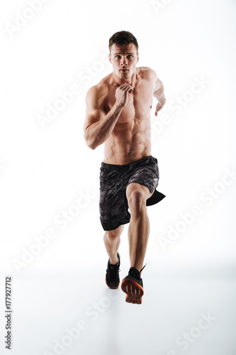 Full length portrait of young attractive runner in motion