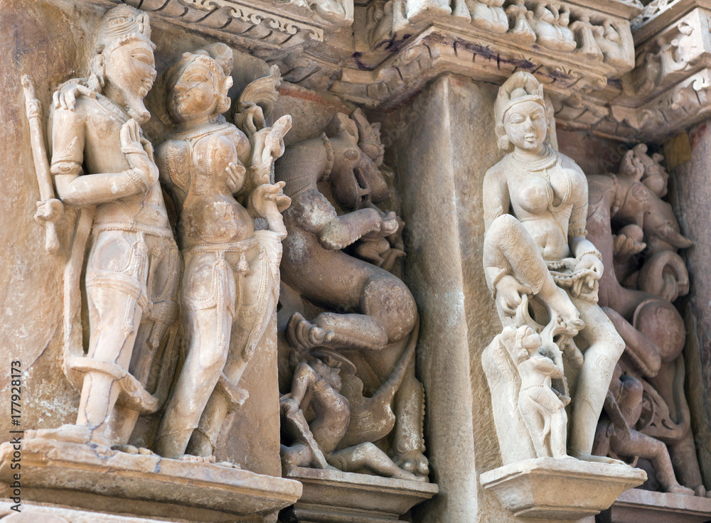 Shiva, Parvati and Apsara - ancient bas-relief at famous erotic temple in Khajuraho, India
