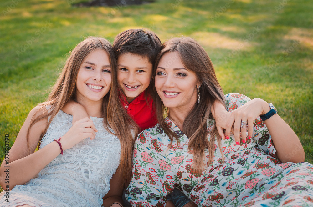 Obraz premium Happy family having fun in the summer at the park. Mom and children.