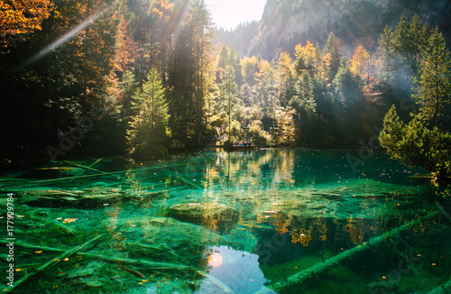 Autumn time at forest lake Blausee.